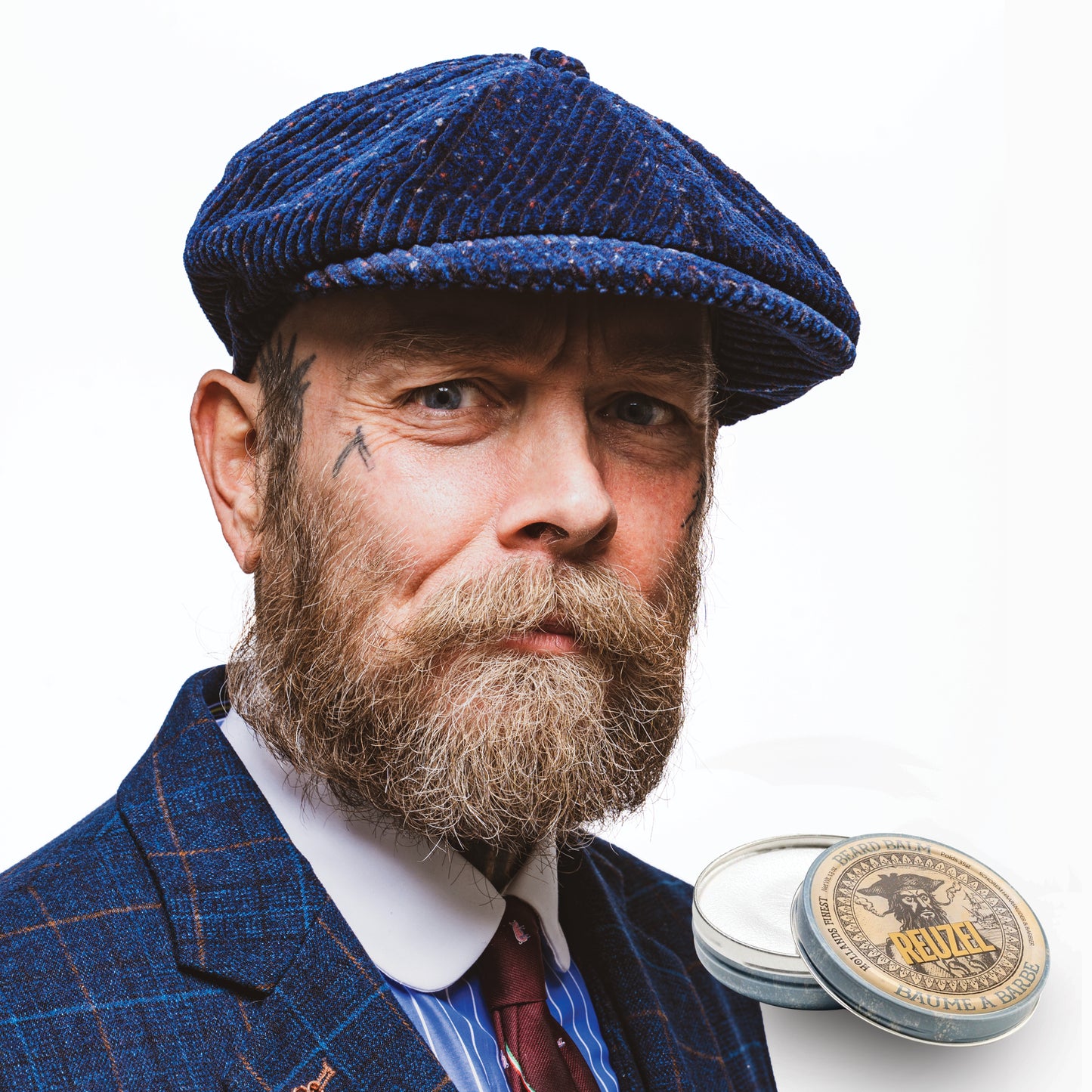 Reuzel Deutschland beard balm jar with black and red label, showing a close-up of the product for beard grooming.