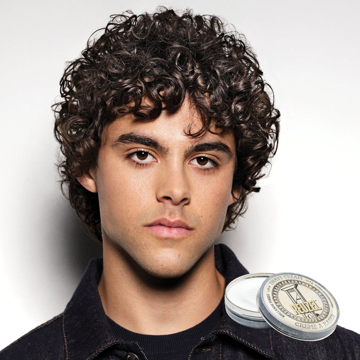 Reuzel Deutschland beard shave cream in a jar, showing a smooth, creamy texture ideal for close facial shaves.