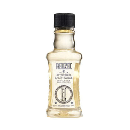 Reuzel Deutschland Wood & Spice aftershave in a glass bottle, featuring earthy and spicy scent for beard grooming.