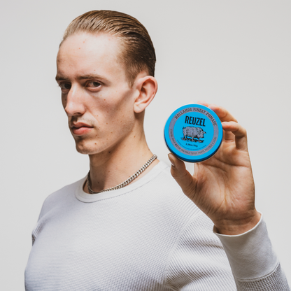 Reuzel Blue Pomade jar with blue label, showing the classic pomade container for men's styling and grooming.
