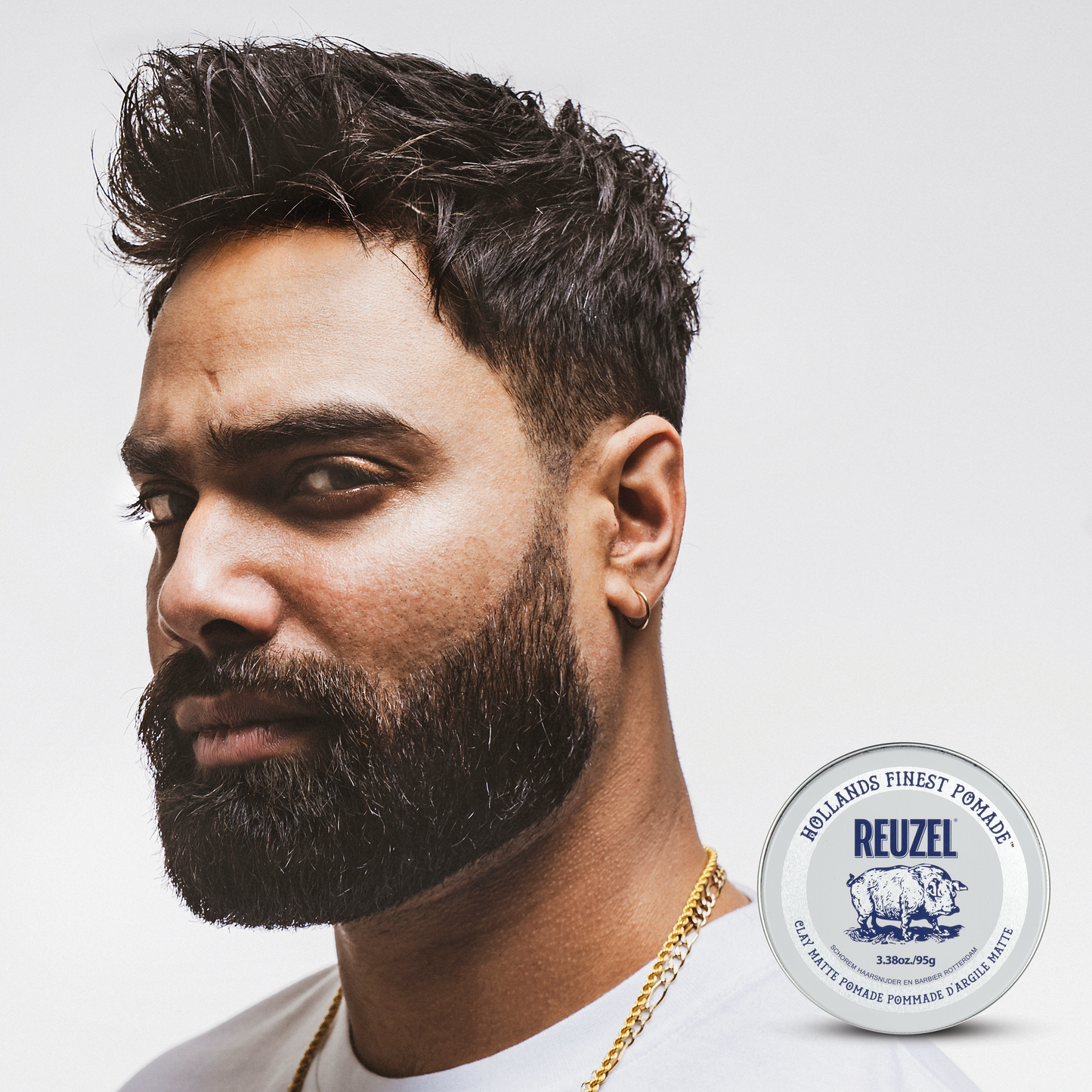 Reuzel Deutschland Clay Matte Pomade jar with label, showcasing the product's thick, matte styling formula for textured hair.