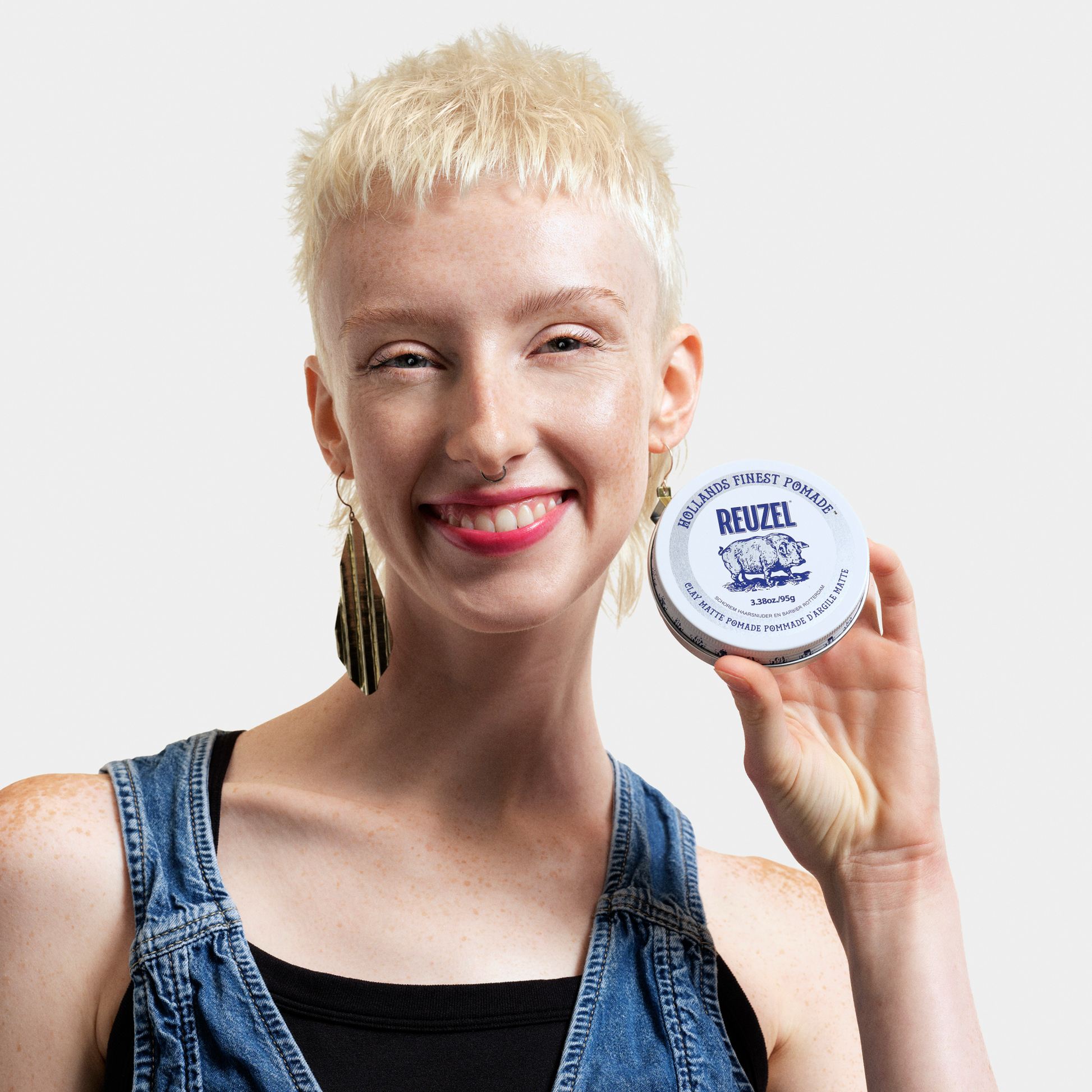 Reuzel Deutschland Clay Matte Pomade jar with label, showing its thick, matte hair styling product for textured, matte finish hairstyles.