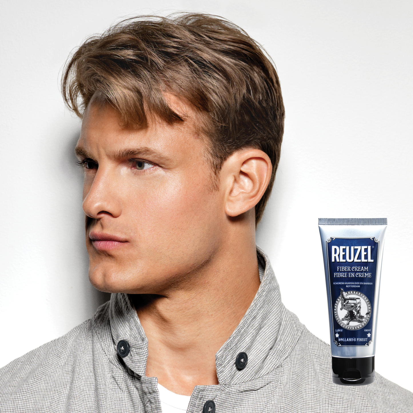 Reuzel Deutschland Fiber Cream hair styling product in a jar, showcasing its thick, creamy texture for strong hold and flexible style.