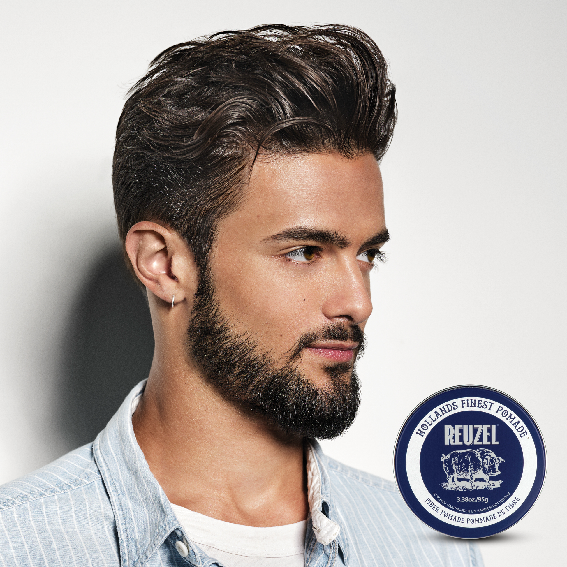 Reuzel Fiber Pomade jar with black lid and label, showcasing the grooming product for textured, flexible hairstyle hold.