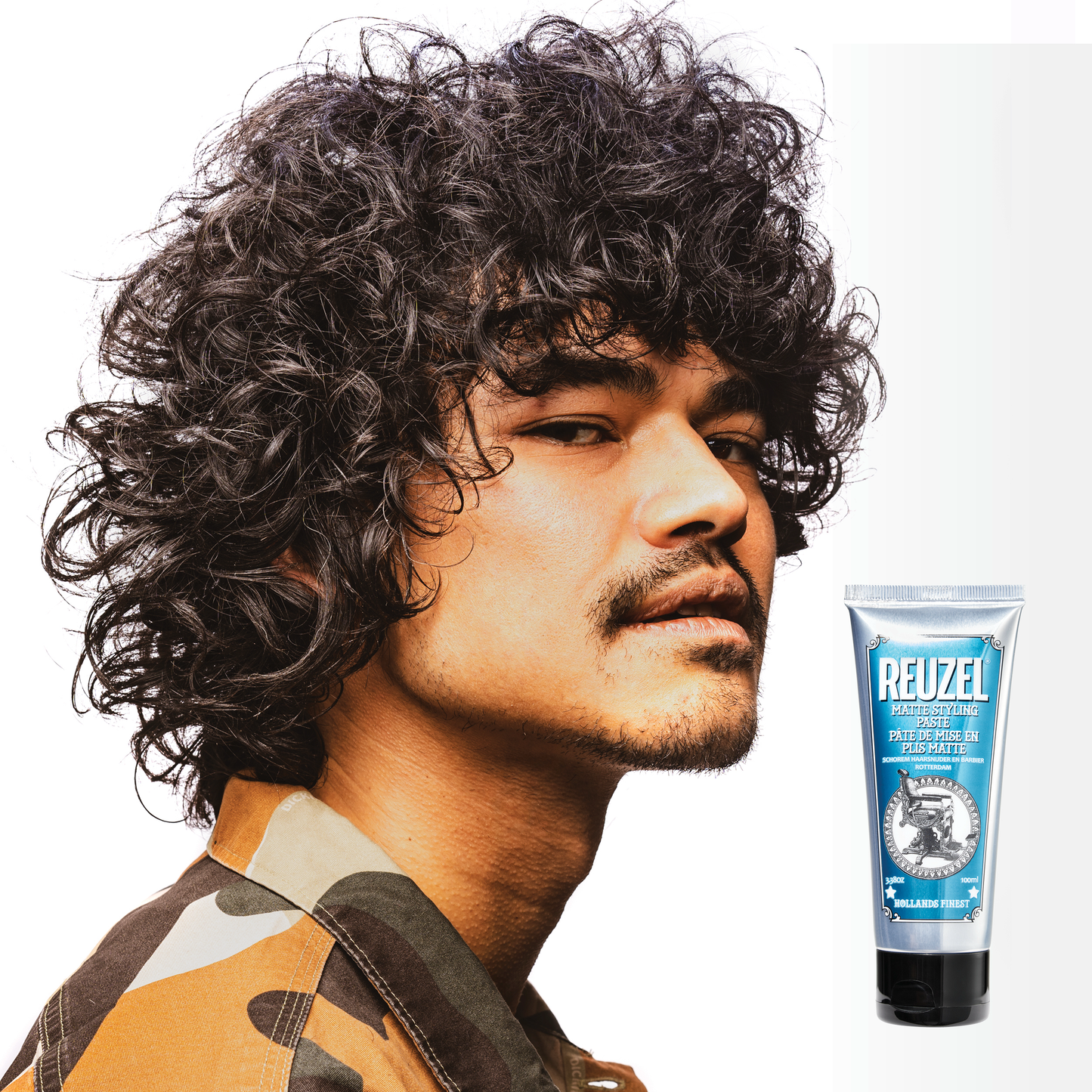 Reuzel Deutschland grooming cream for hair styling, showing a jar of grooming cream with a black lid and label.