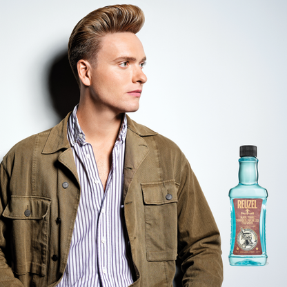 Reuzel Deutschland Hair Tonic bottle with white label and black cap, displayed on a plain background.