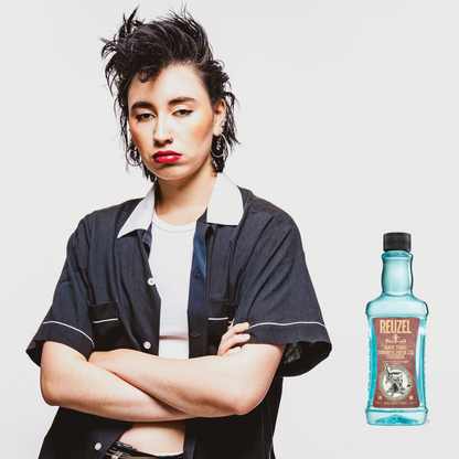 Reuzel Deutschland Hair Tonic bottle with pump dispenser, featuring a sleek label and clear liquid inside.