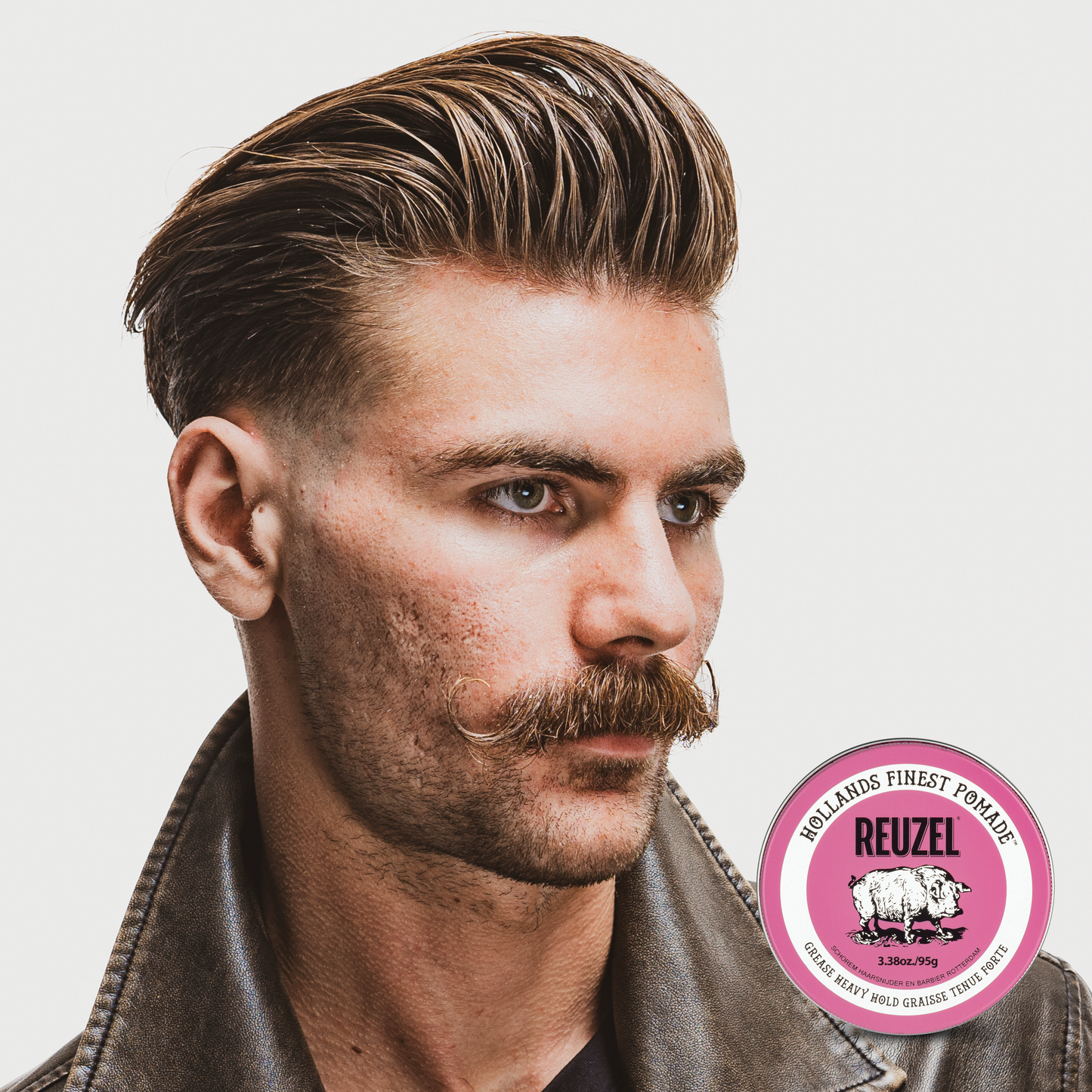 Reuzel Deutschland Pink Pomade jar with pink label and lid, ideal for styling hair with a strong hold and shiny finish.