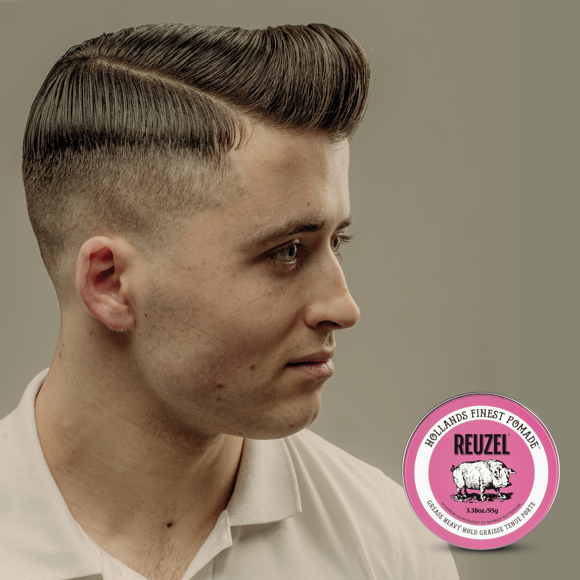 Reuzel Pink Pomade jar showcasing the classic pink label and lid, ideal for styling and shaping hair with a glossy finish.