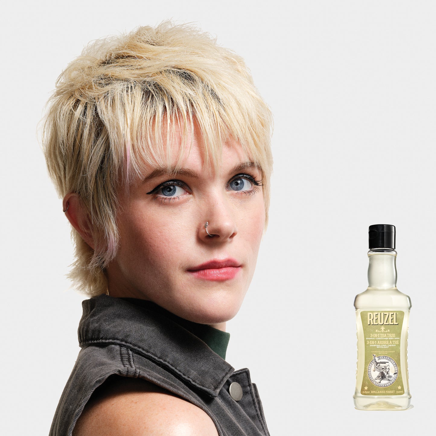 Reuzel Deutschland 3-in-1 Tea Tree Shampoo, Conditioner, and Body Wash bottle with label and pump dispenser.