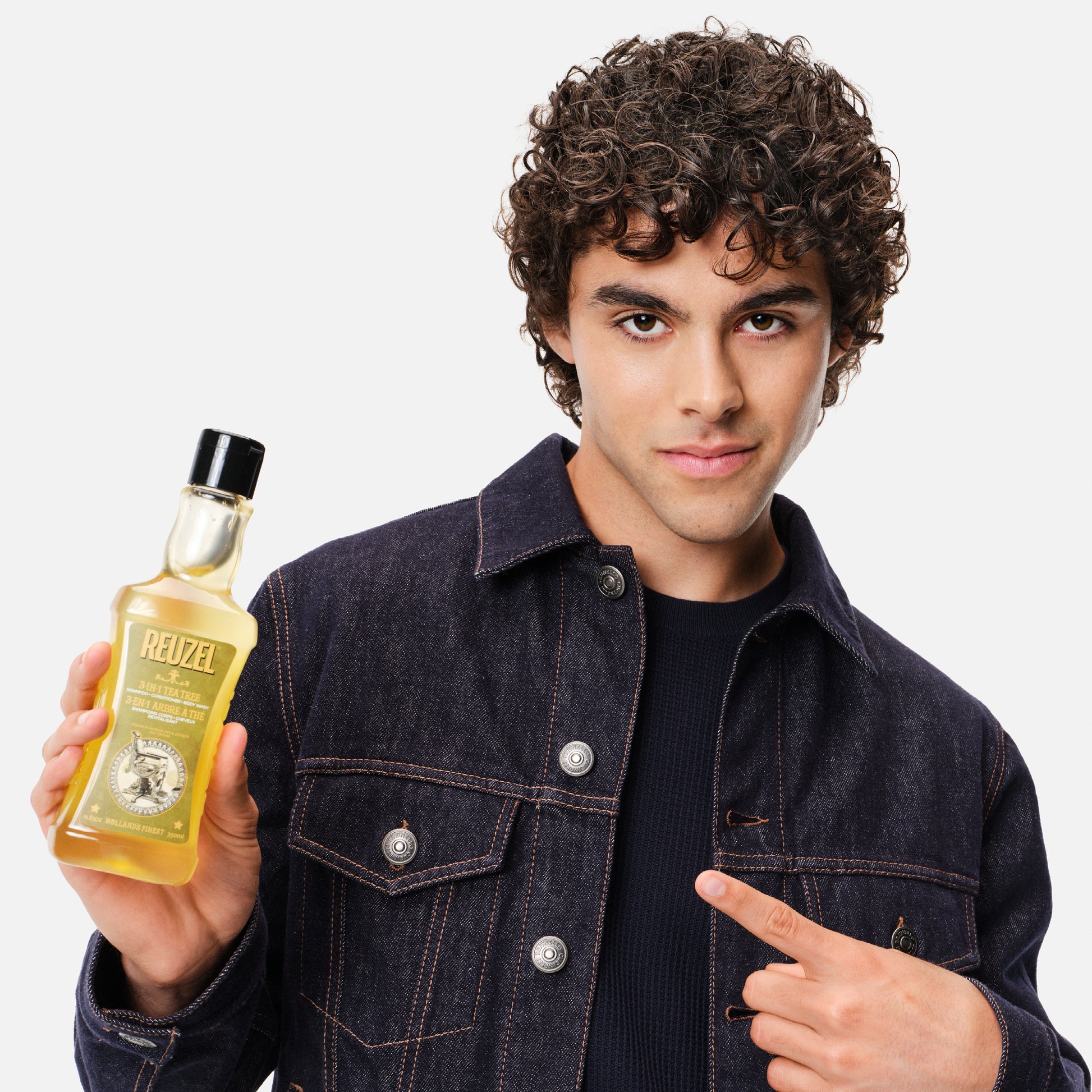 Reuzel Deutschland 3-in-1 tea tree shampoo, conditioner, and body wash bottle with label and pump dispenser.