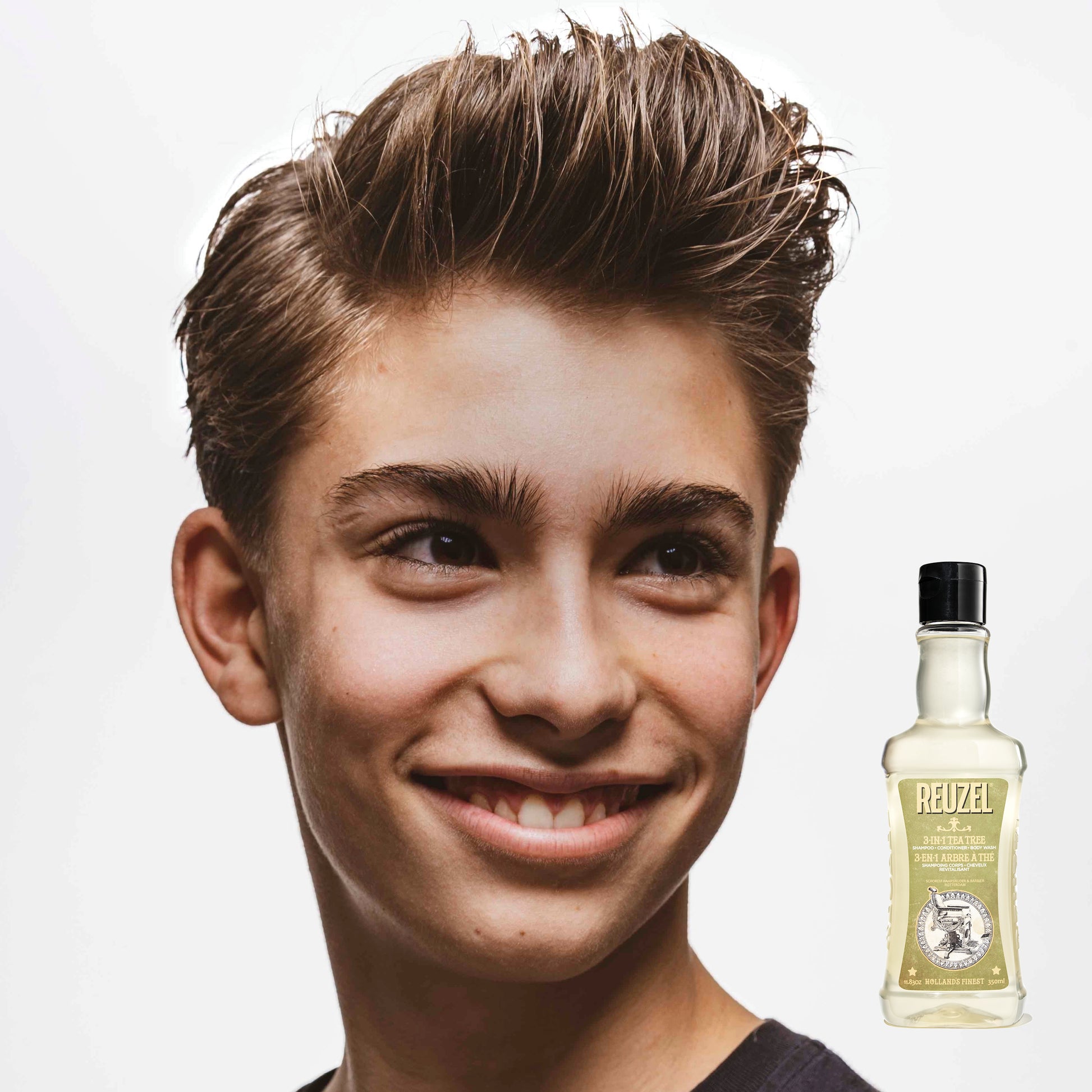 Reuzel Deutschland 3-in-1 Tea Tree shampoo, conditioner, and body wash bottle with label and pump dispenser.