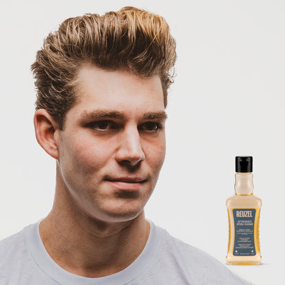 Reuzel Deutschland aftershave bottle with label, showcasing a modern design and branding for men's grooming.