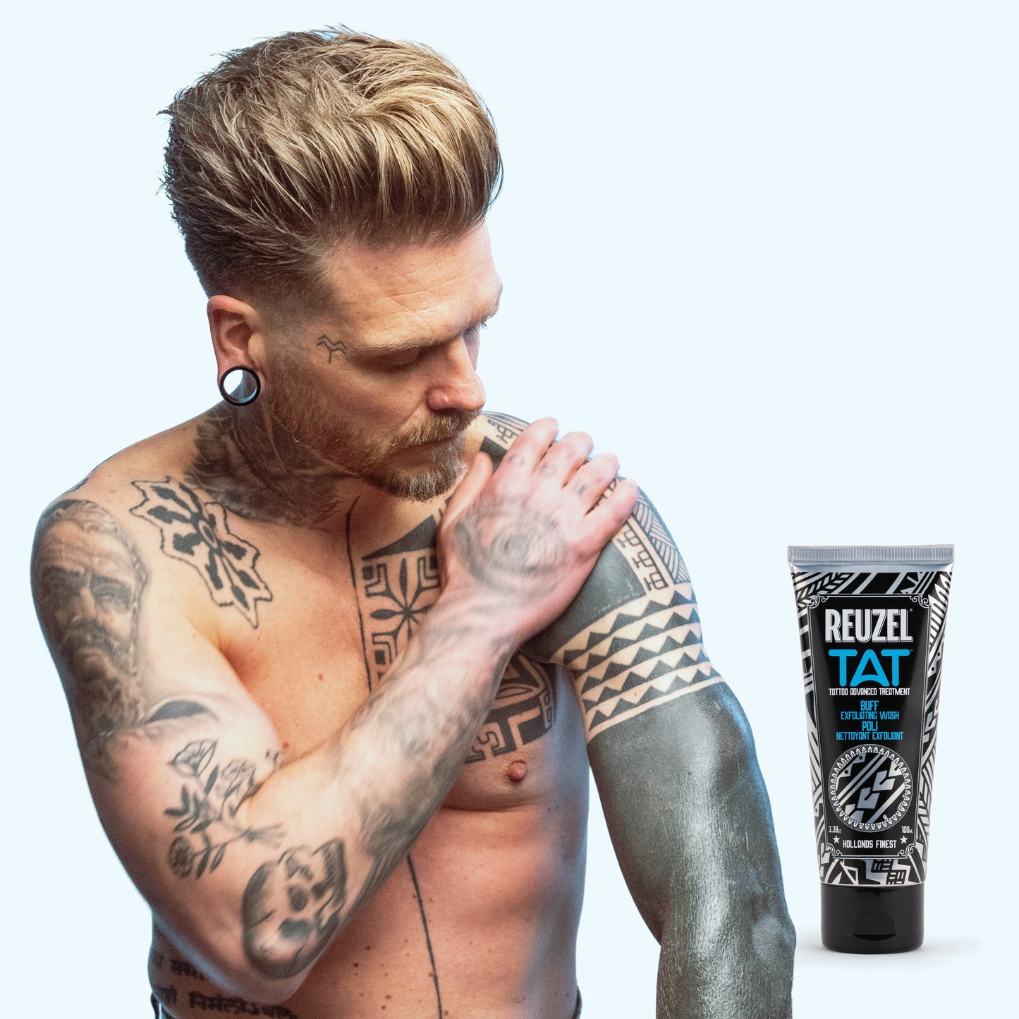 Reuzel Deutschland Buff Exfoliating Wash for tattoo aftercare, clear bottle with pump dispenser and label, set against a neutral background.