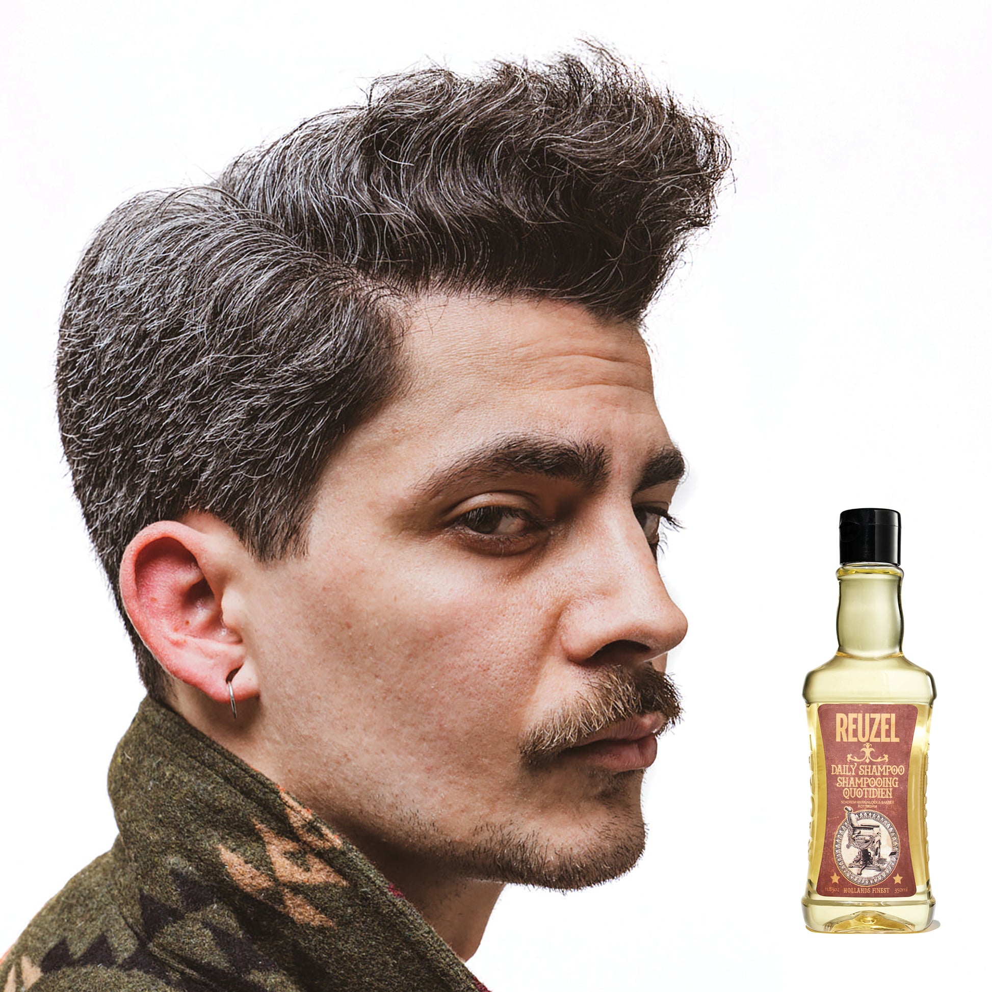 Reuzel Deutschland Daily Shampoo in a clear bottle with a black pump, designed for cleansing hair and scalp.