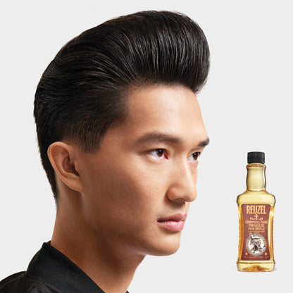 Reuzel Deutschland grooming tonic bottle for hair, featuring a sleek design and label with branding and product details.