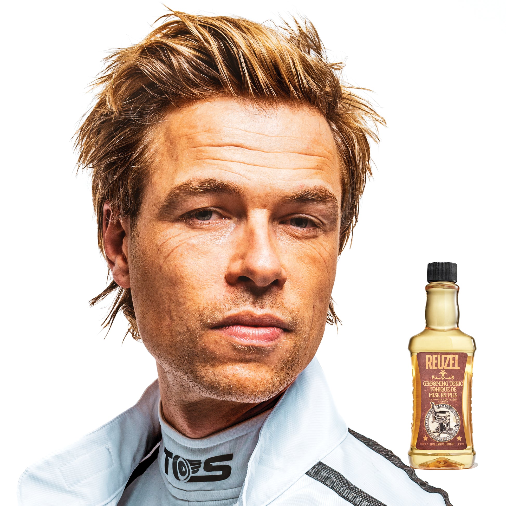 Reuzel Deutschland Grooming Tonic hair tonic bottle with label, designed for styling and scalp care.