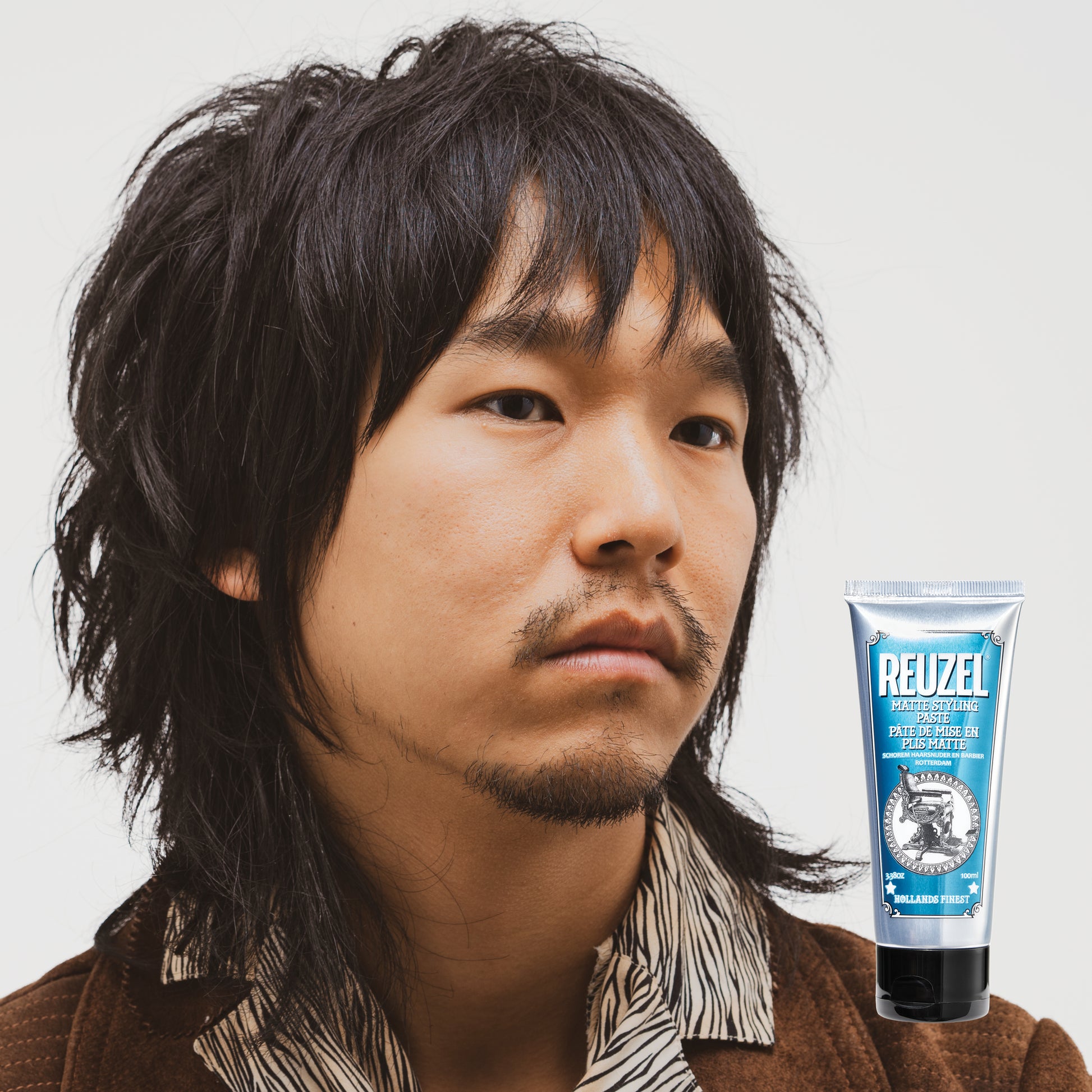 Reuzel Deutschland matte styling paste in a jar, showing its smooth, matte-textured hair styling product for textured, natural looks.