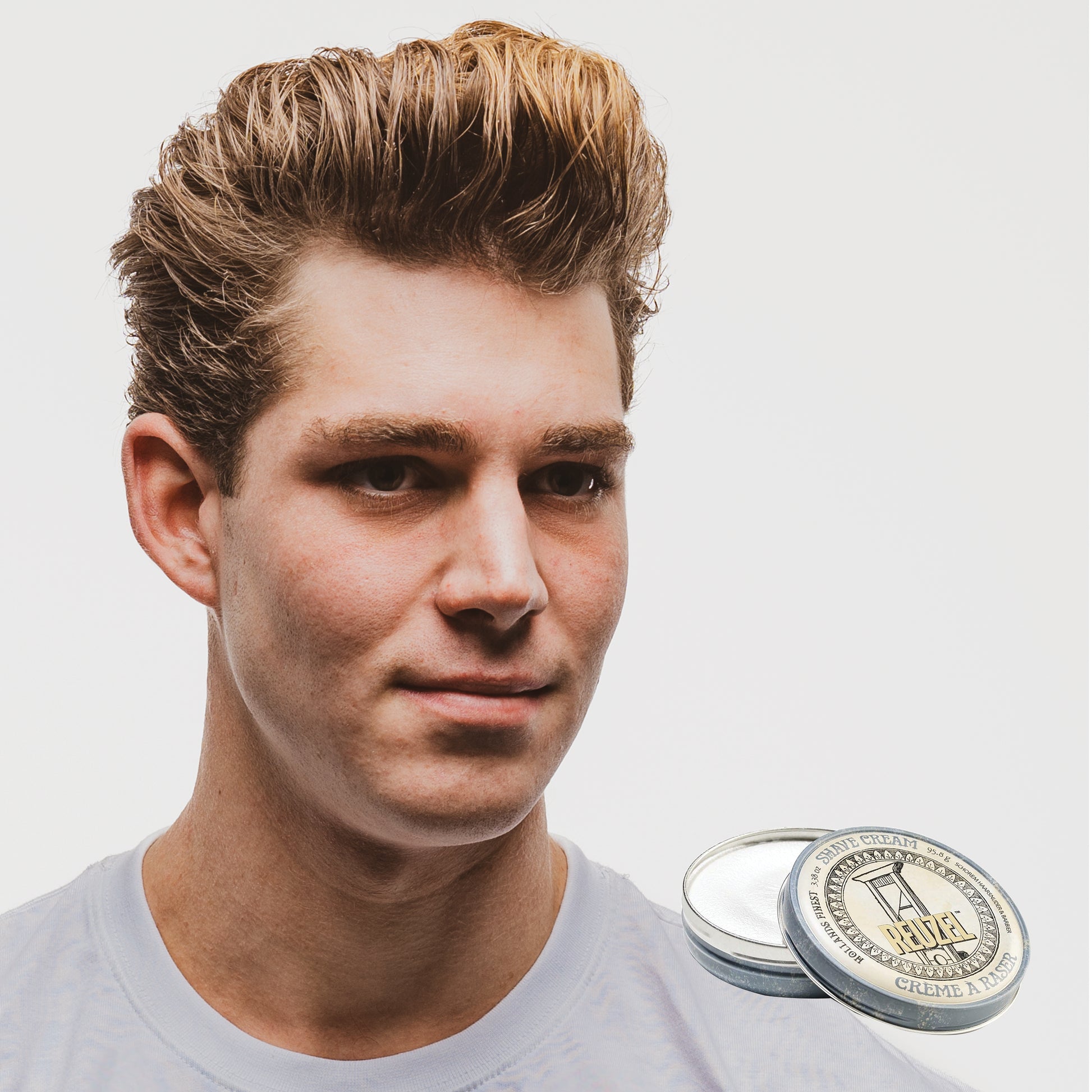 Reuzel Deutschland shave cream in a jar, showcasing smooth, creamy texture ideal for beard grooming and shaving.