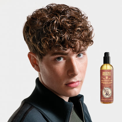 Reuzel Deutschland Spray Grooming Tonic bottle, hair tonic for styling and grooming, with a spray nozzle and label visible.