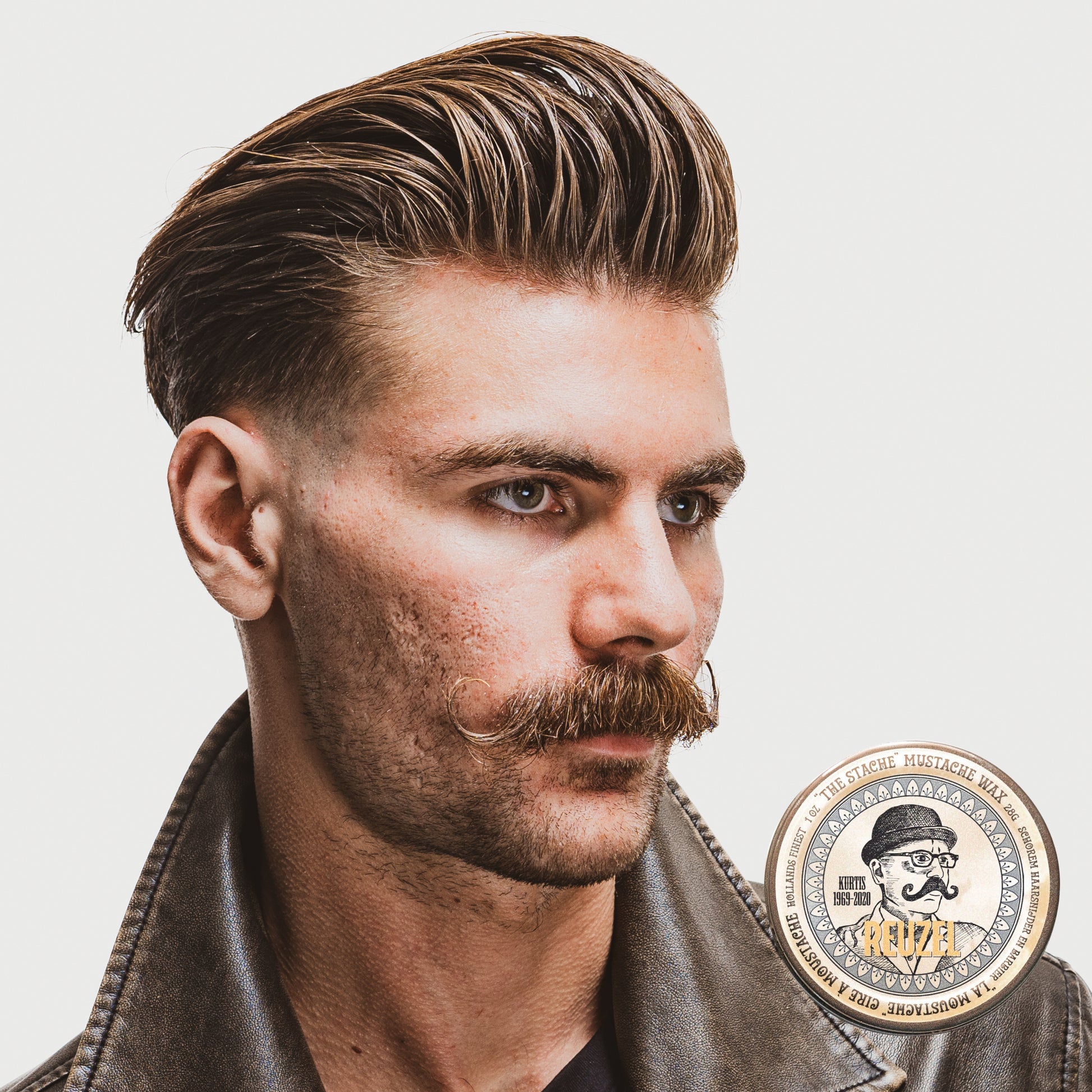 Reuzel Deutschland The Stache Mustache Wax jar with black lid and label, beard grooming product for mustache styling.