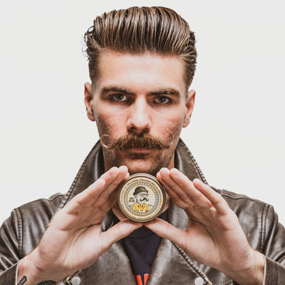 Reuzel Deutschland The Stache Mustache Wax jar with black lid and label, used for shaping and styling mustaches.