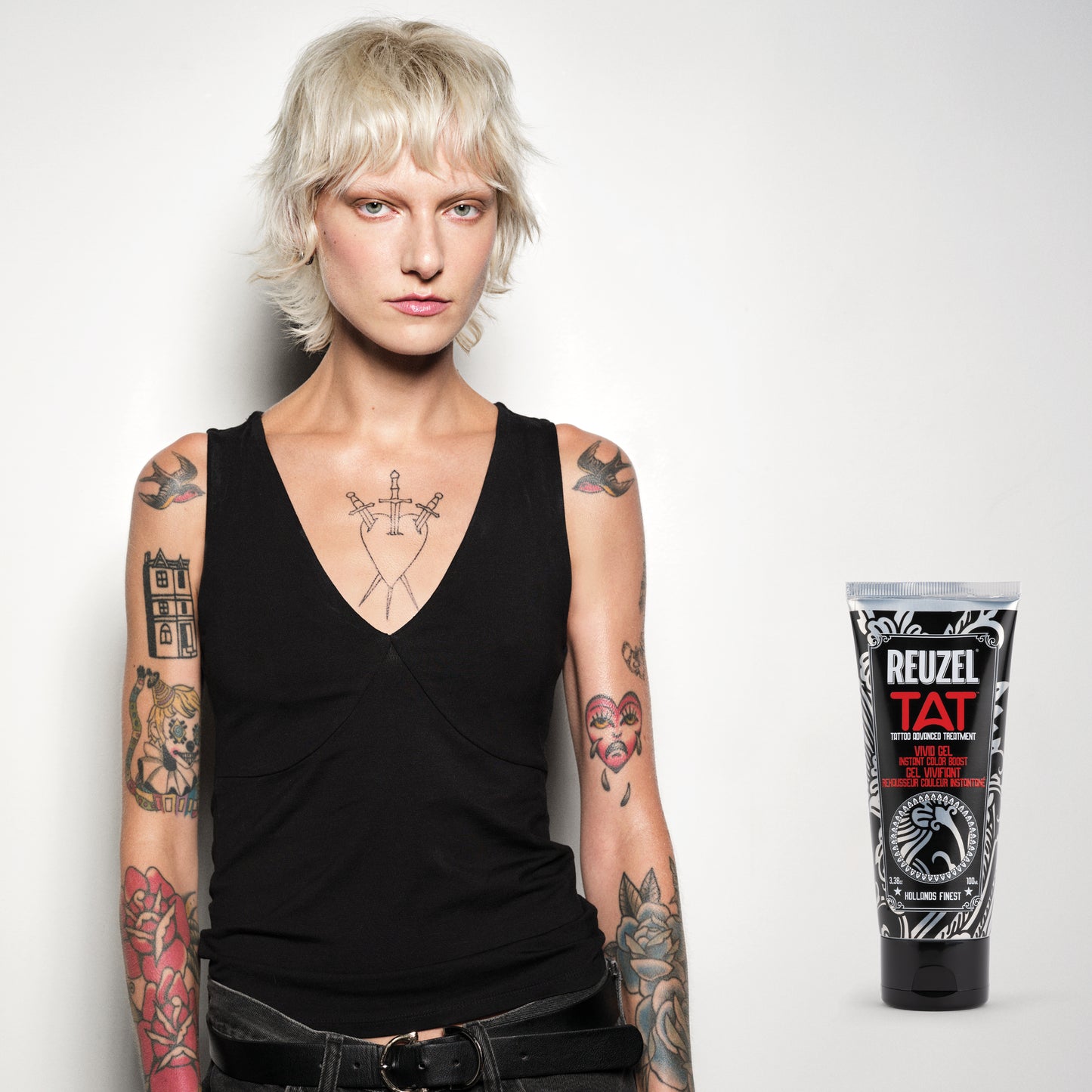 Person with tattoos next to a Reuzel TAT VIVID Gel for tattoo aftercare product, showing the gel in a tube, designed for skin healing and protection