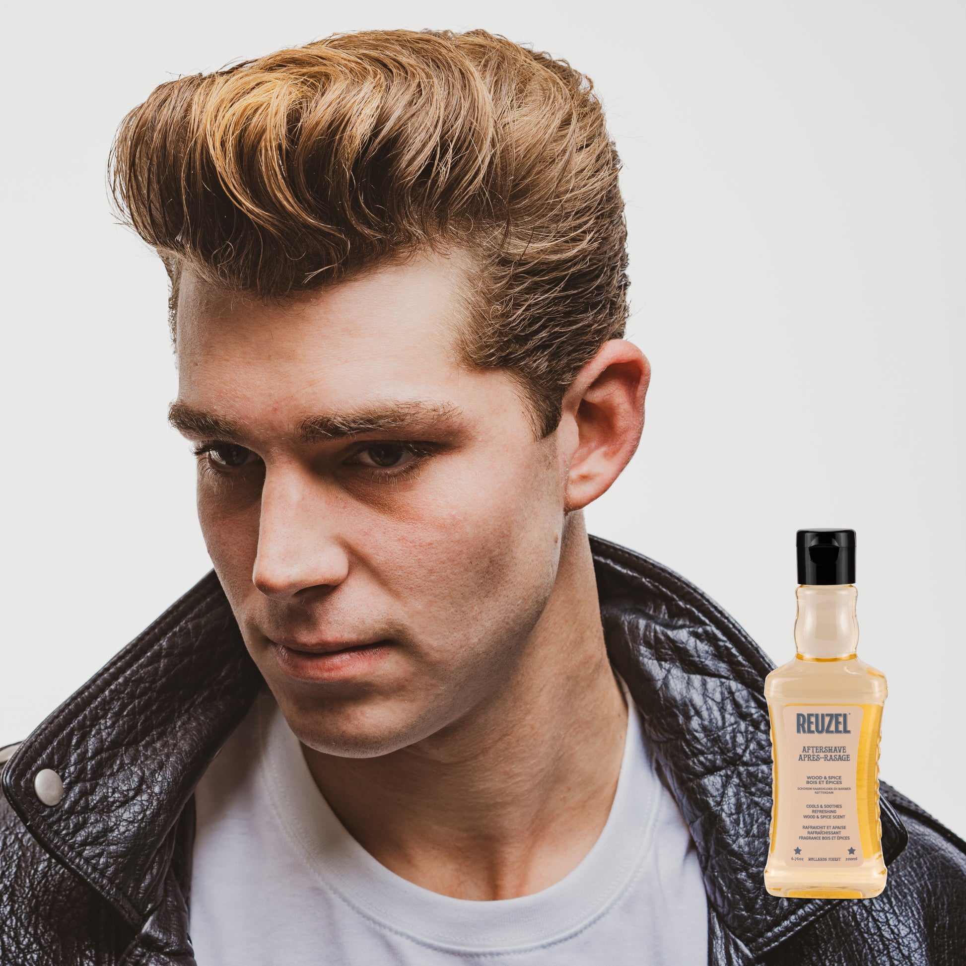 Reuzel Deutschland Wood & Spice Beard Aftershave bottle with a wood and spice scent, featuring a sleek design and label.