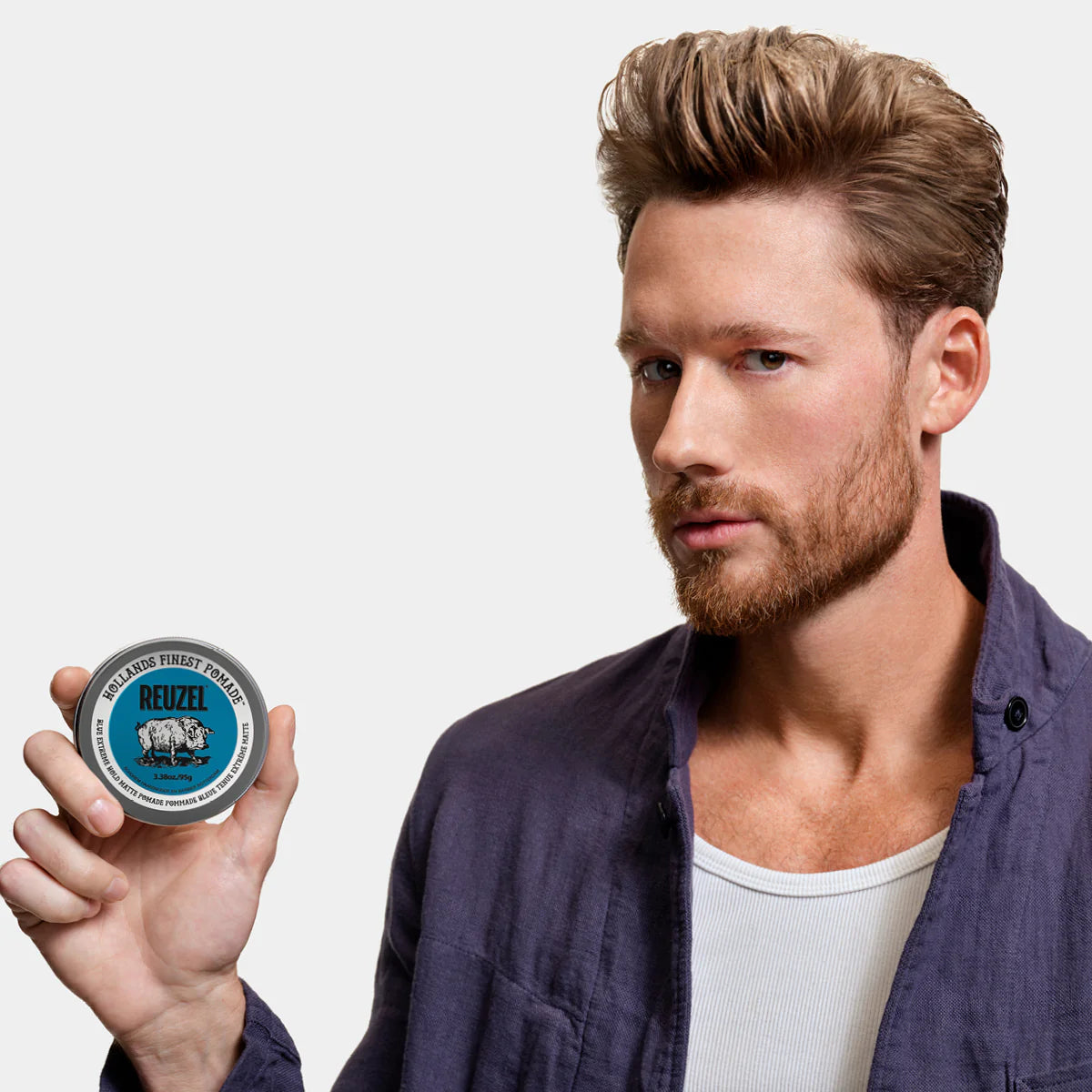 Blue Reuzel Deutschland Extreme Hold Matte Pomade jar with label, designed for strong, matte hairstyle hold.